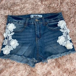 White flower cutoff jean shorts